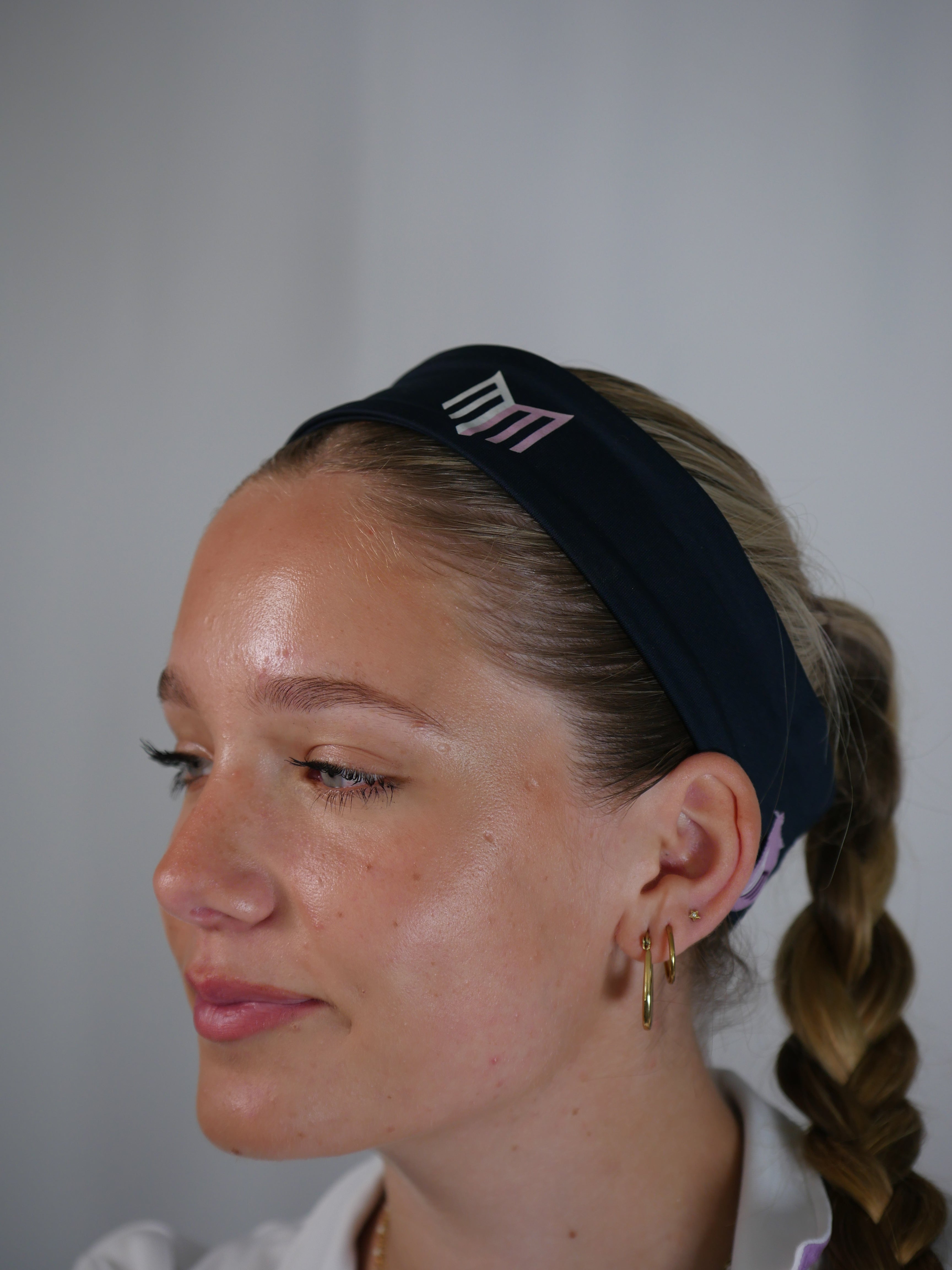  a blue headband with a logo on a plain background
