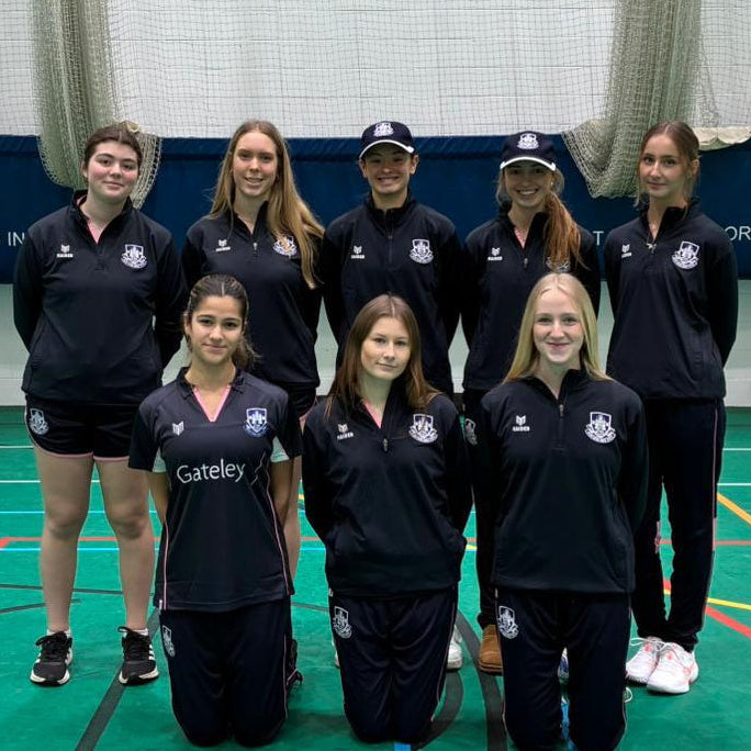 a women's team of 8 in a team photo, wearing blue Maiden team kit.