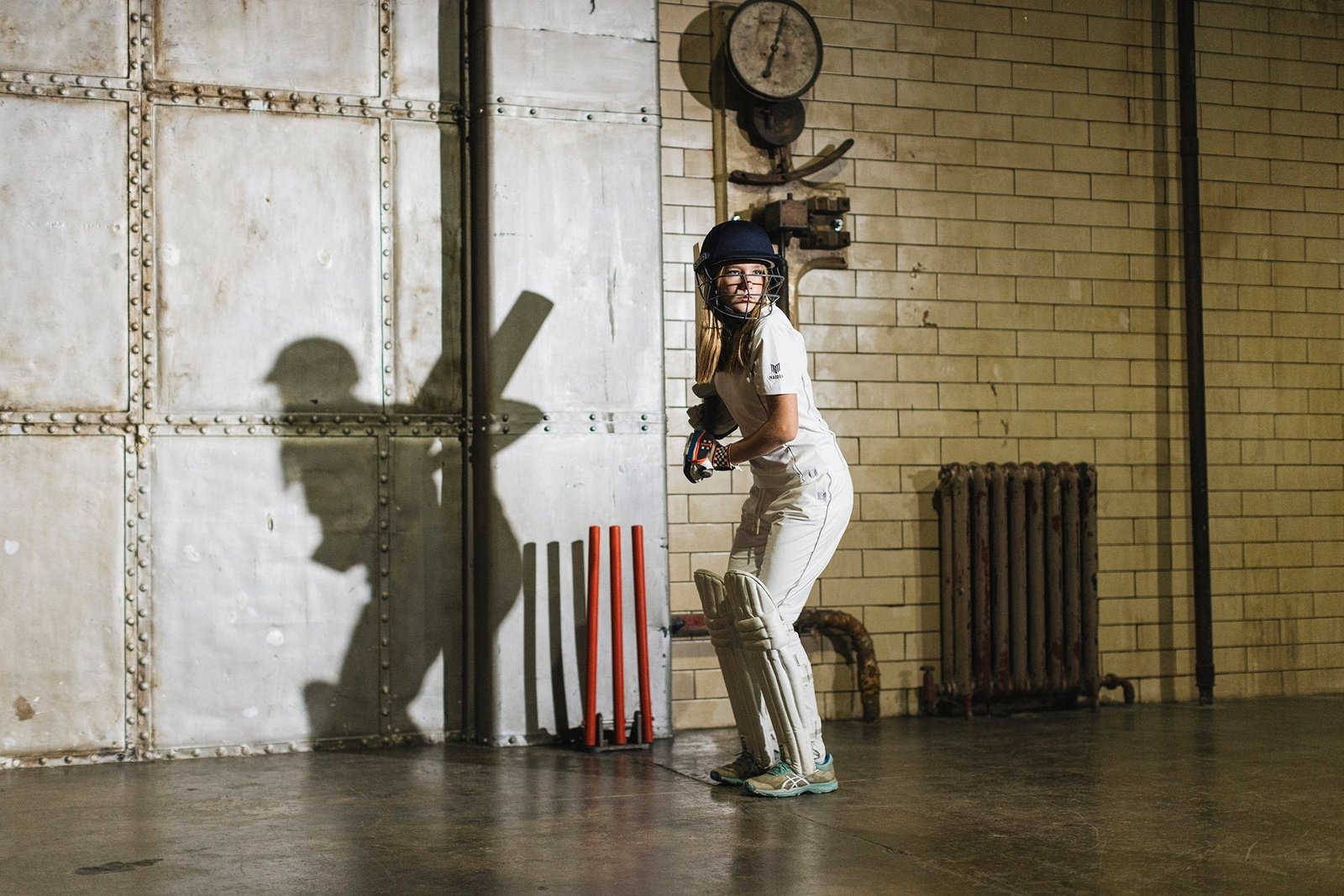 Female cricketer in action wearing ladies cricket wear