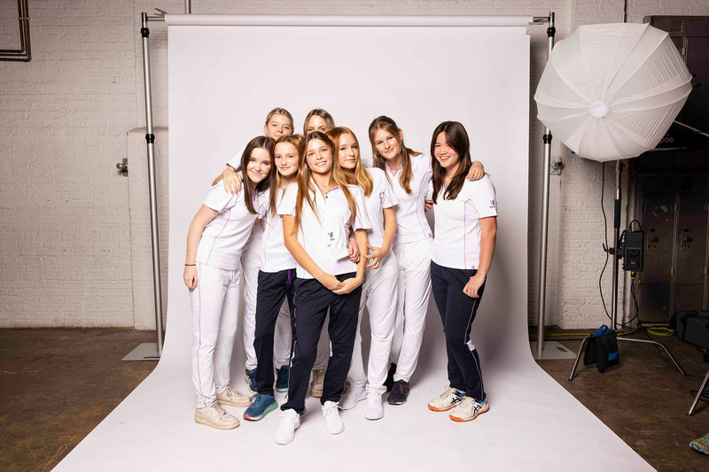 Girls joyfully showcasing Maiden's ladies cricket wear.