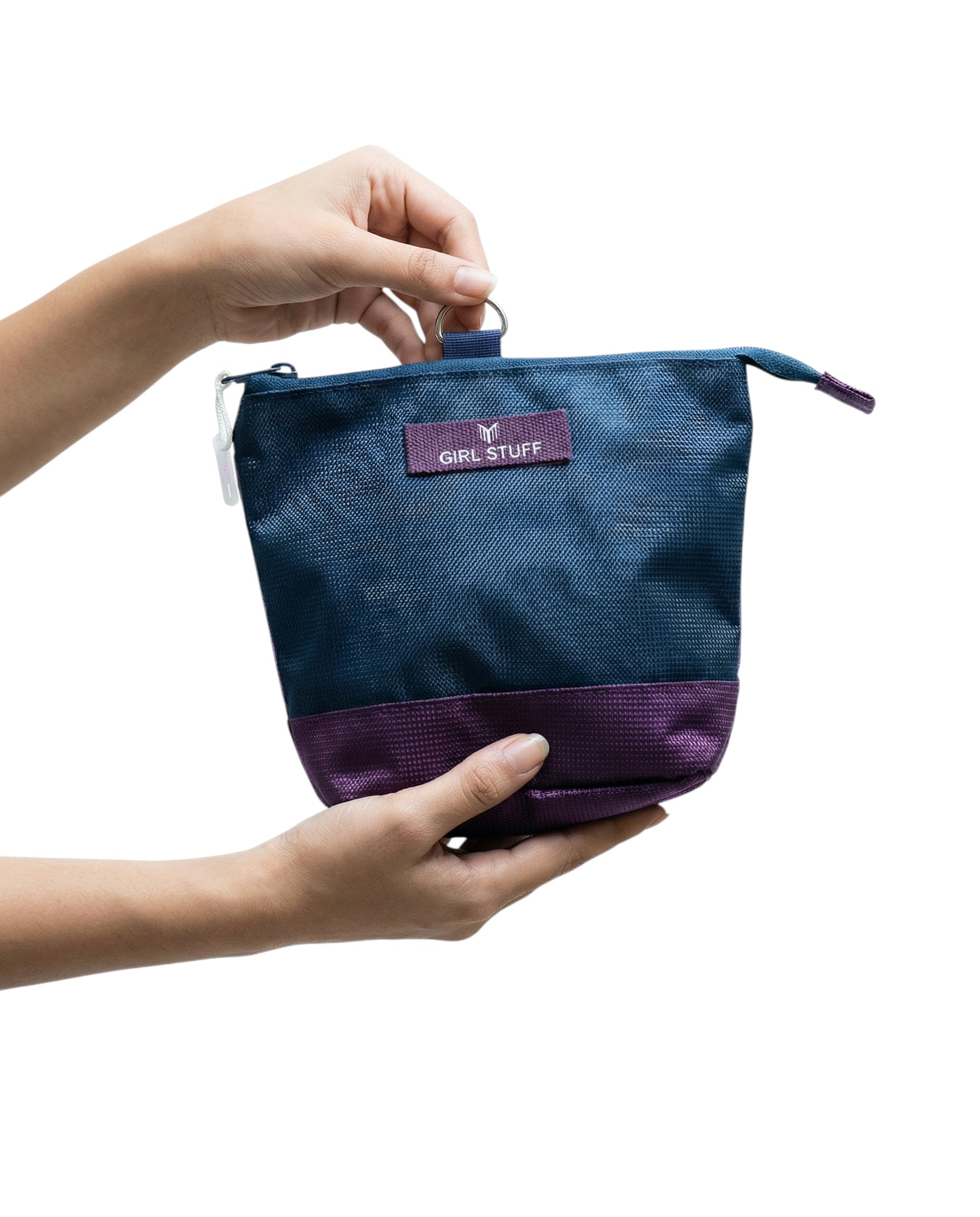 Maiden Cricket detachable essentials pouch in navy and purple, held by hands against a white background.