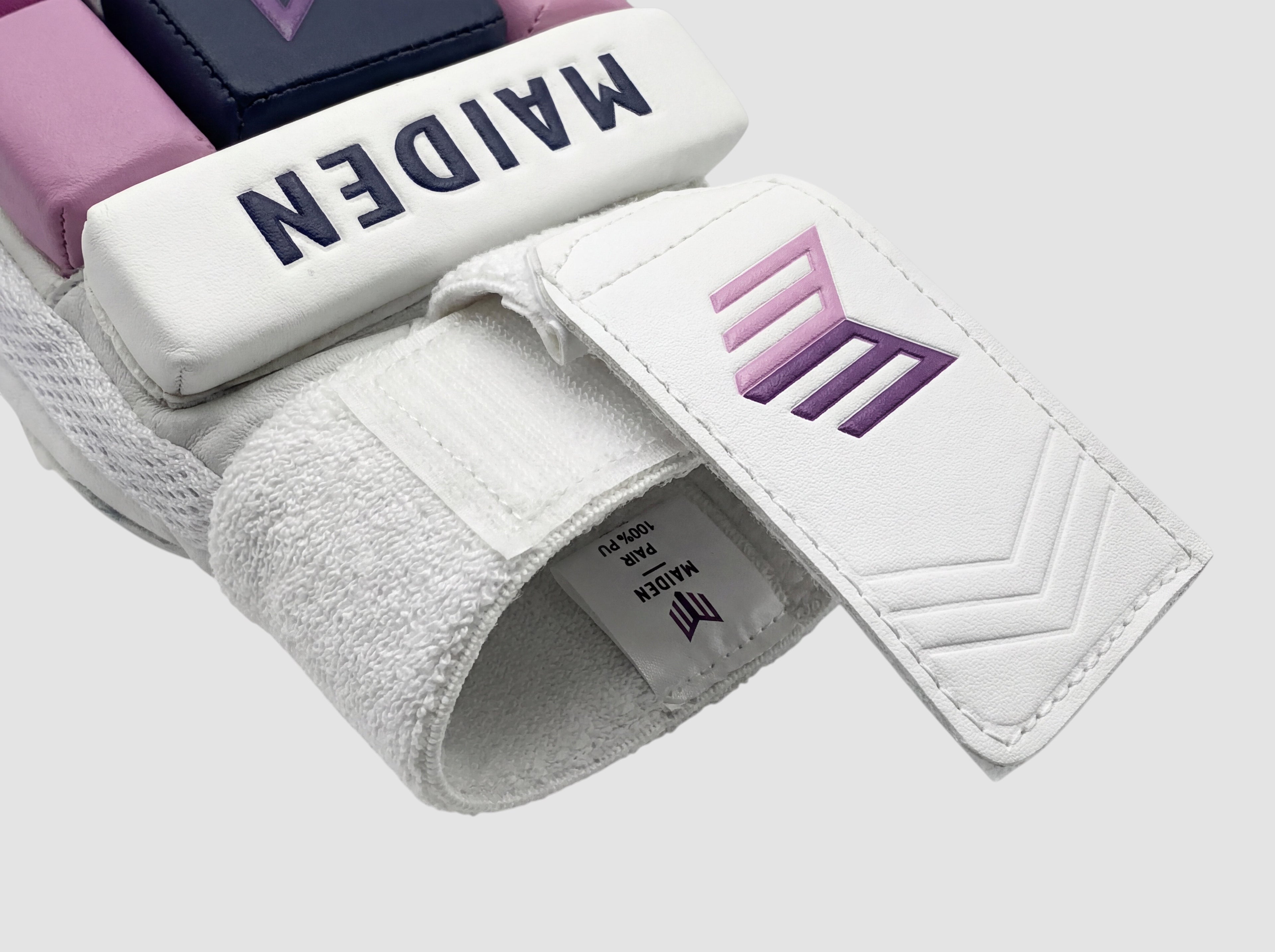 Maiden Cricket girls batting glove featuring white PU, navy and pink padding, and a moisture-absorbing sweatband.