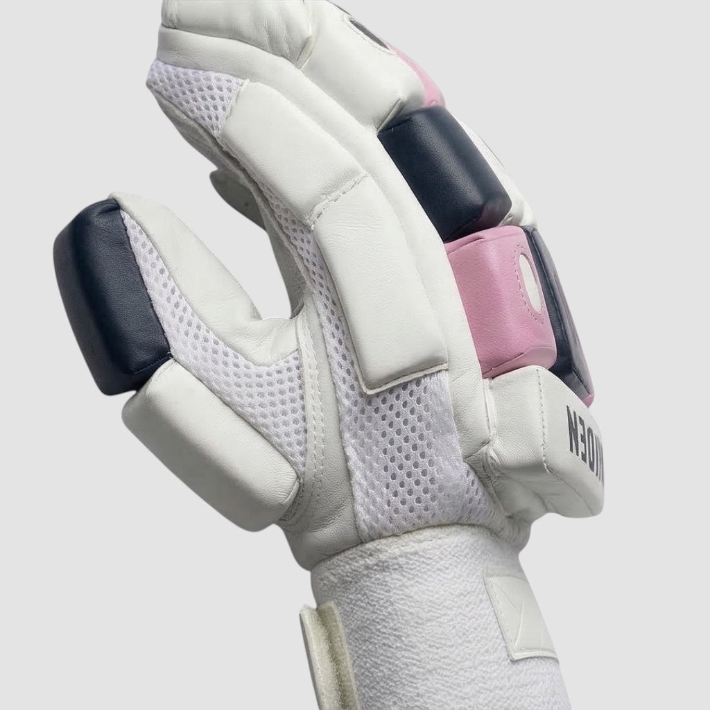 Maiden Cricket girls batting gloves with white sheepskin palm, pink and navy foam padding, and mesh airflow zones.