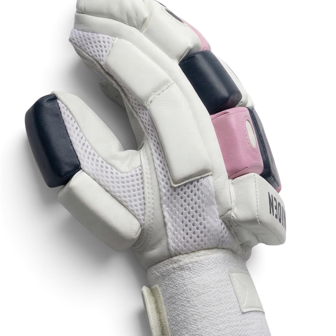 Maiden Cricket batting gloves for girls featuring white leather, navy and pink foam padding, and mesh airflow zones.