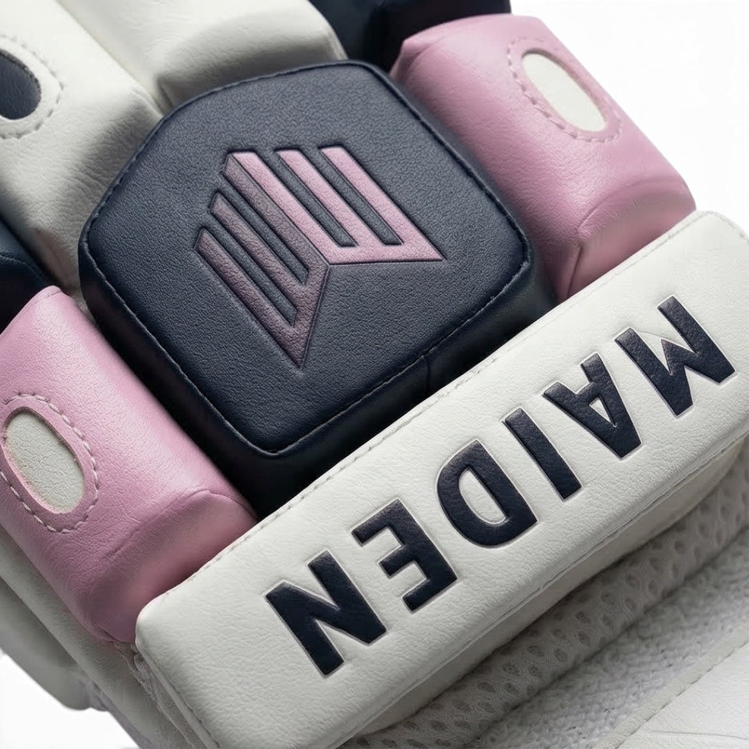 Maiden Cricket batting gloves for girls featuring white, navy, and pink protective foam padding with brand logo