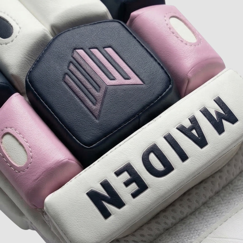 Maiden Cricket batting gloves for girls featuring navy, white, and pink protective foam padding with brand logo