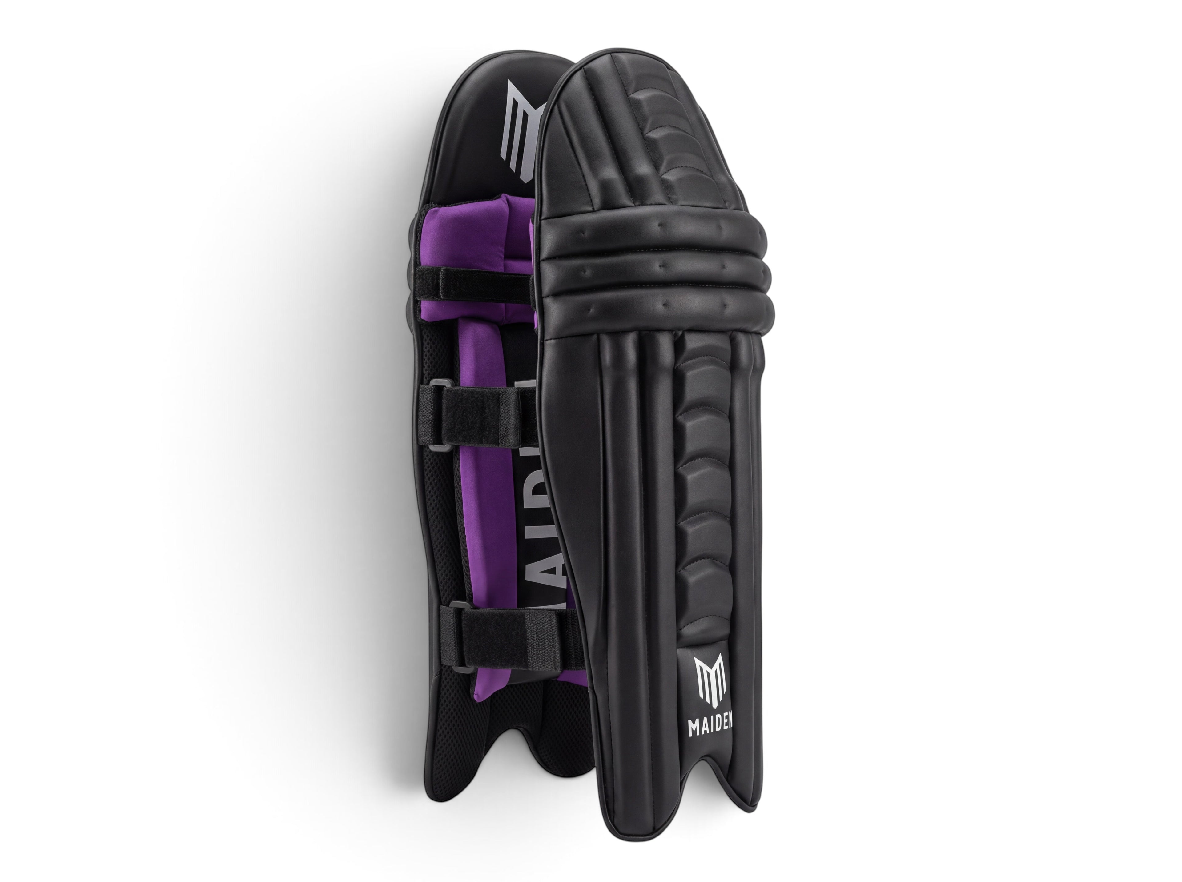 Maiden Cricket girls' black batting pads with ergonomic knee design and purple interior padding for a secure fit.