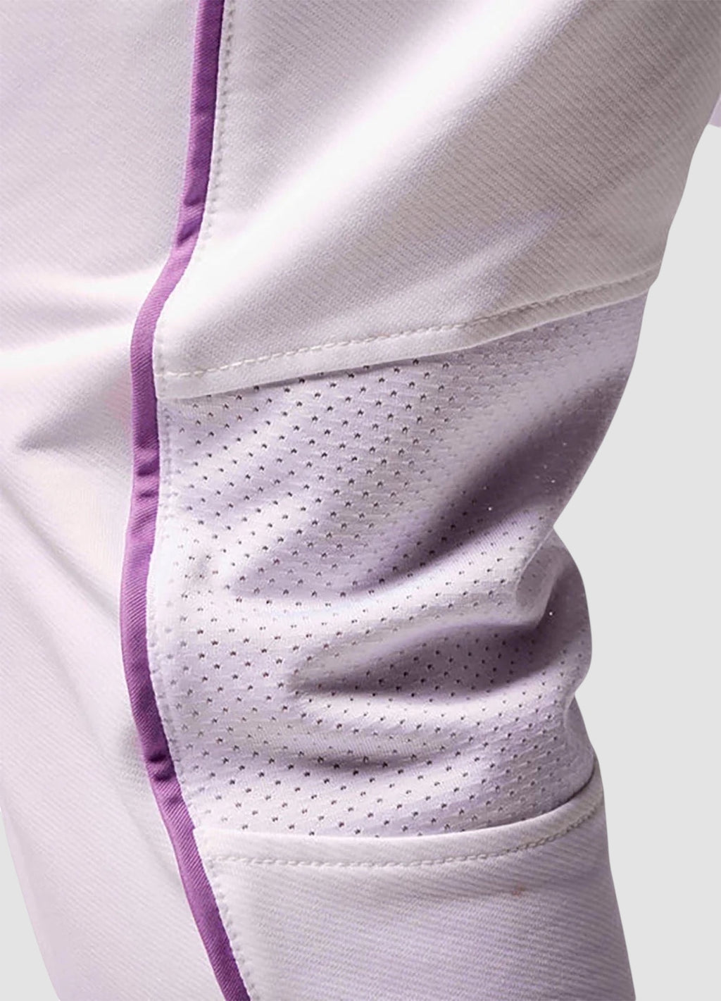 Maiden Cricket girls' white cricket trousers featuring breathable mesh knee vents and purple piping detail.