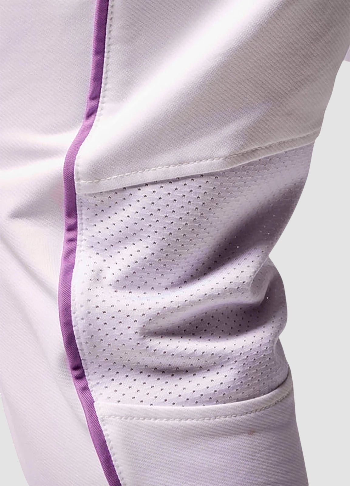 Maiden Cricket girls' white cricket trousers featuring breathable mesh knee vents and purple piping detail.