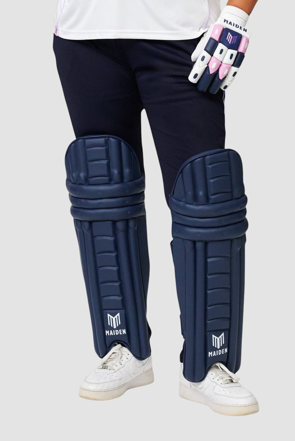Maiden Cricket women's navy batting pads with ergonomic design for a secure fit and lightweight impact protection.
