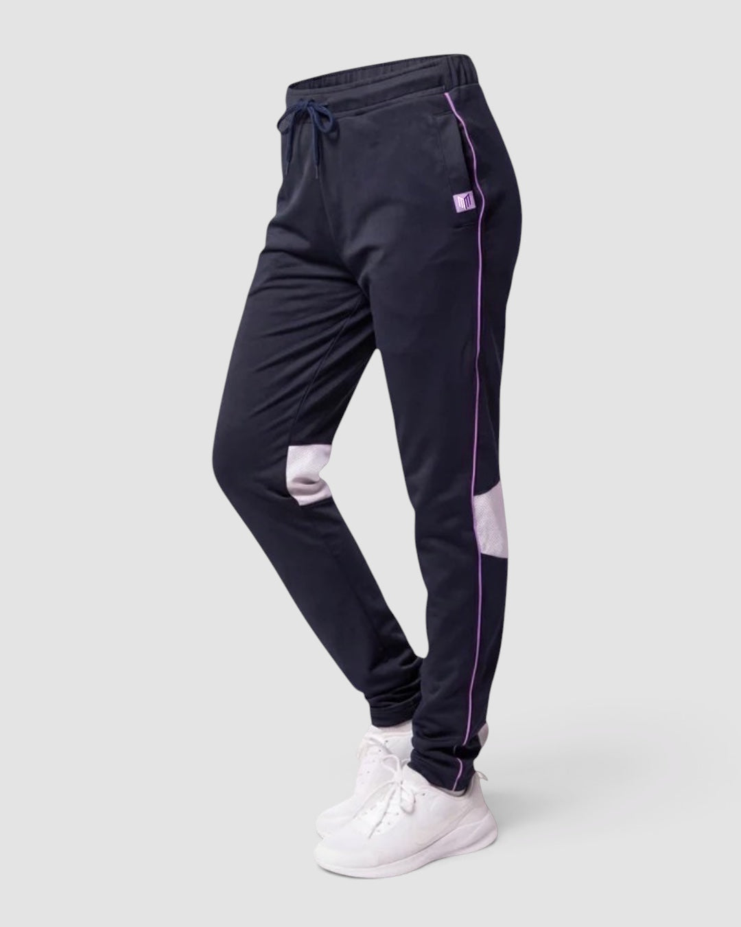 Maiden Cricket Nightwatch girls cricket training trousers in navy with purple piping, mesh knee vents, and waist tie.