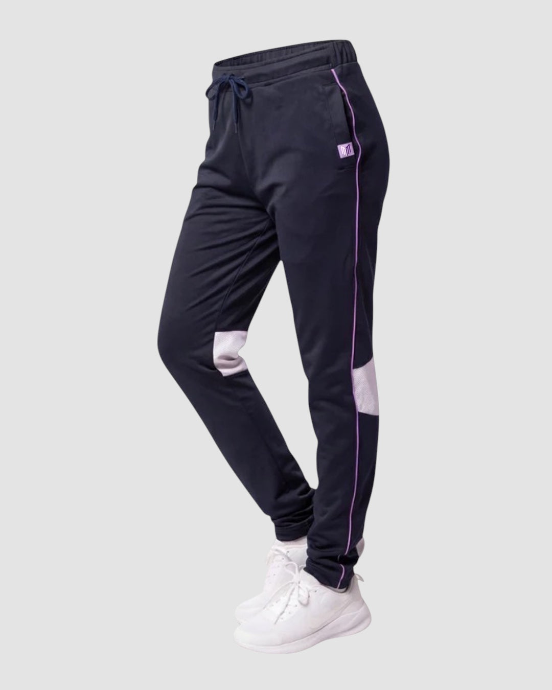 Maiden Cricket Nightwatch women's navy training trousers with purple piping, mesh knee vents, and adjustable hems.