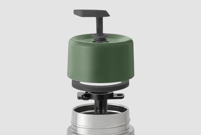 Maiden Cricket x Black+Blum stainless steel travel mug lid components in olive green, showing the leak-proof mechanism.