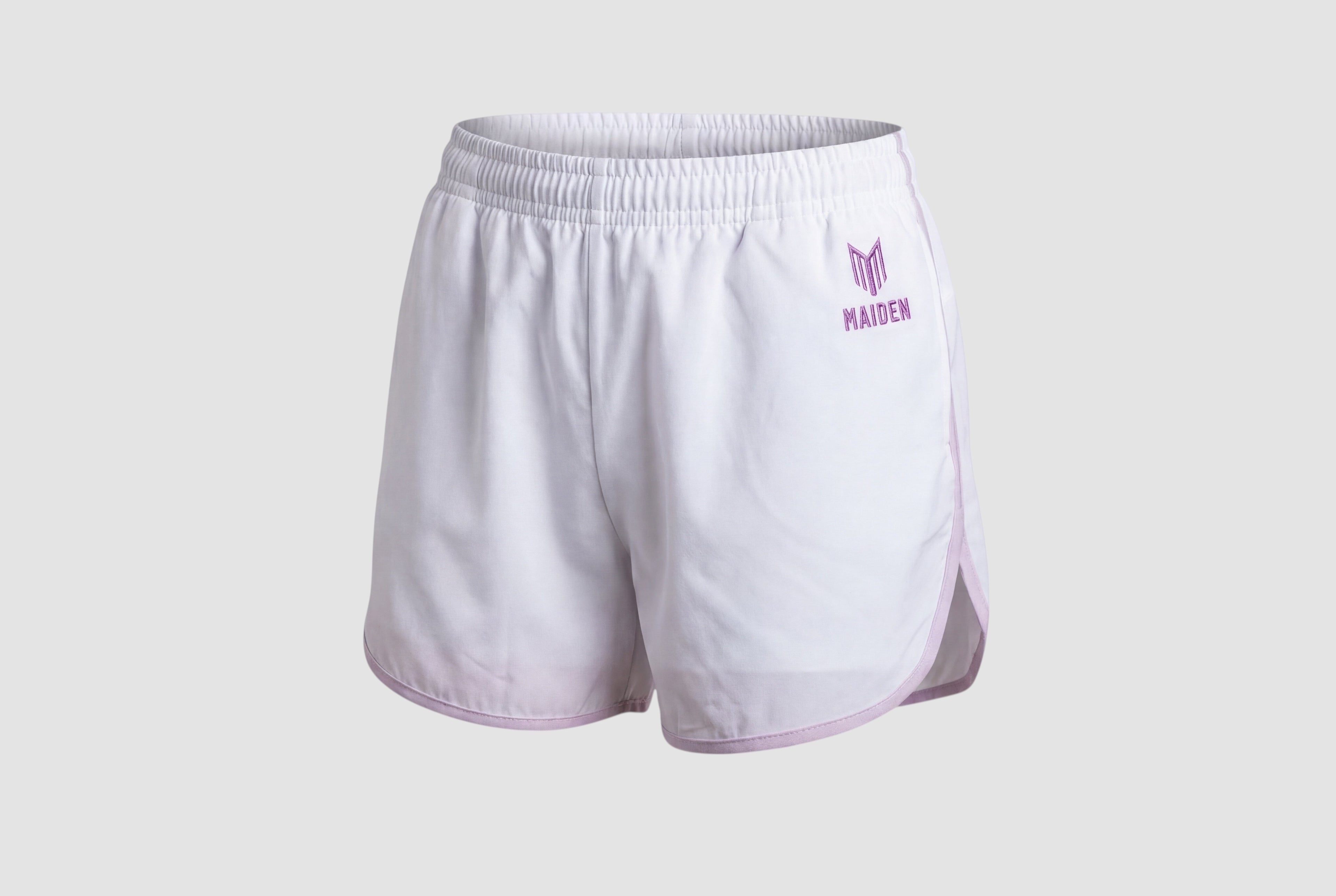 Maiden Cricket white athletic shorts with purple trim, curved hem, and built-in undershorts for women.