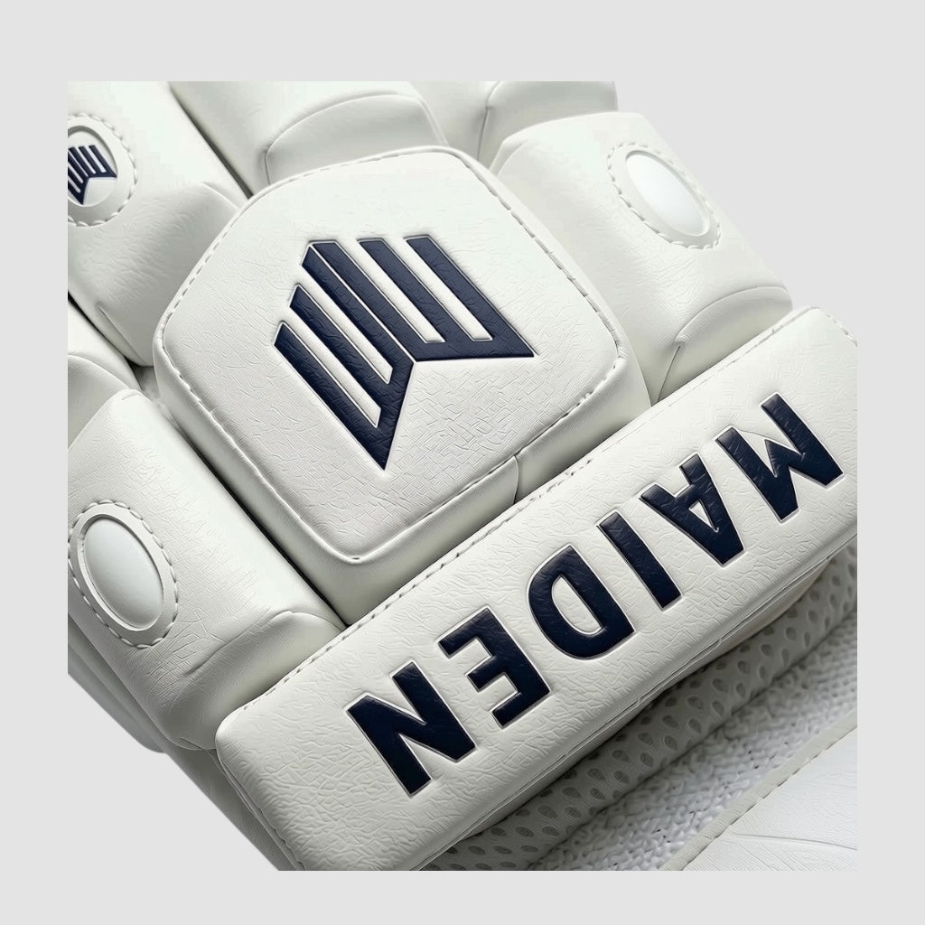 Maiden Cricket white batting gloves with navy blue branding and textured PU outer for girls