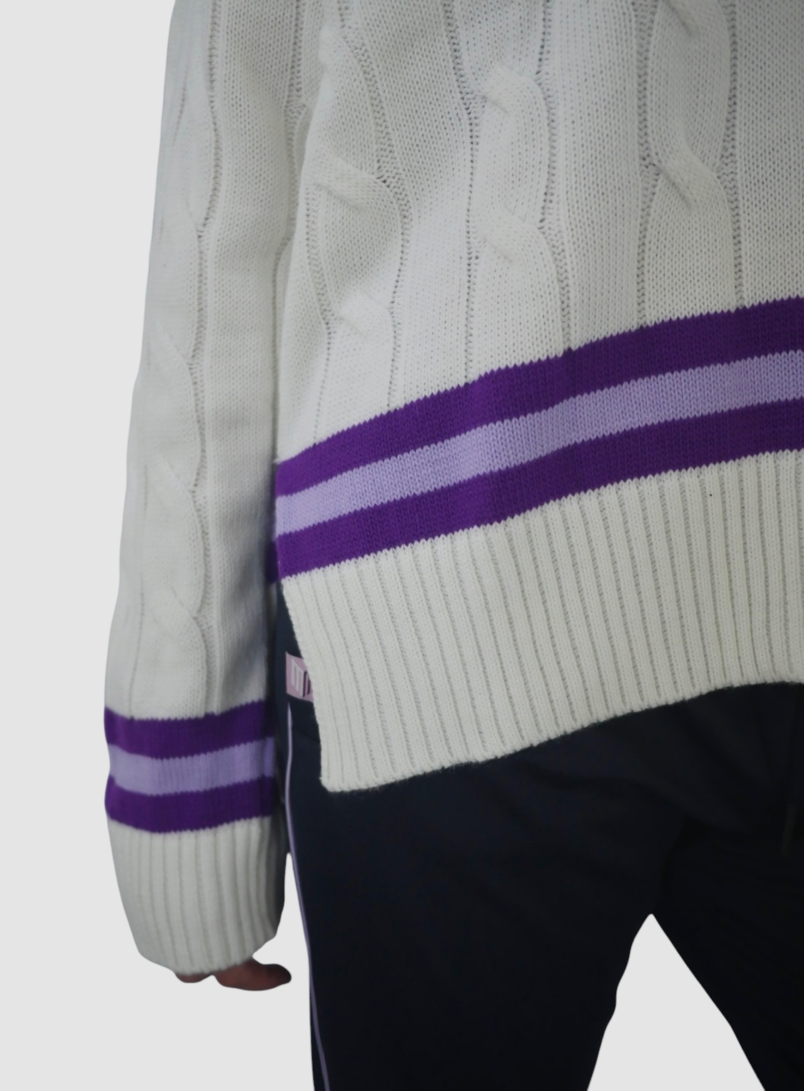 Maiden Cricket women's white cable knit jumper featuring purple striped detailing on the cuffs and hem