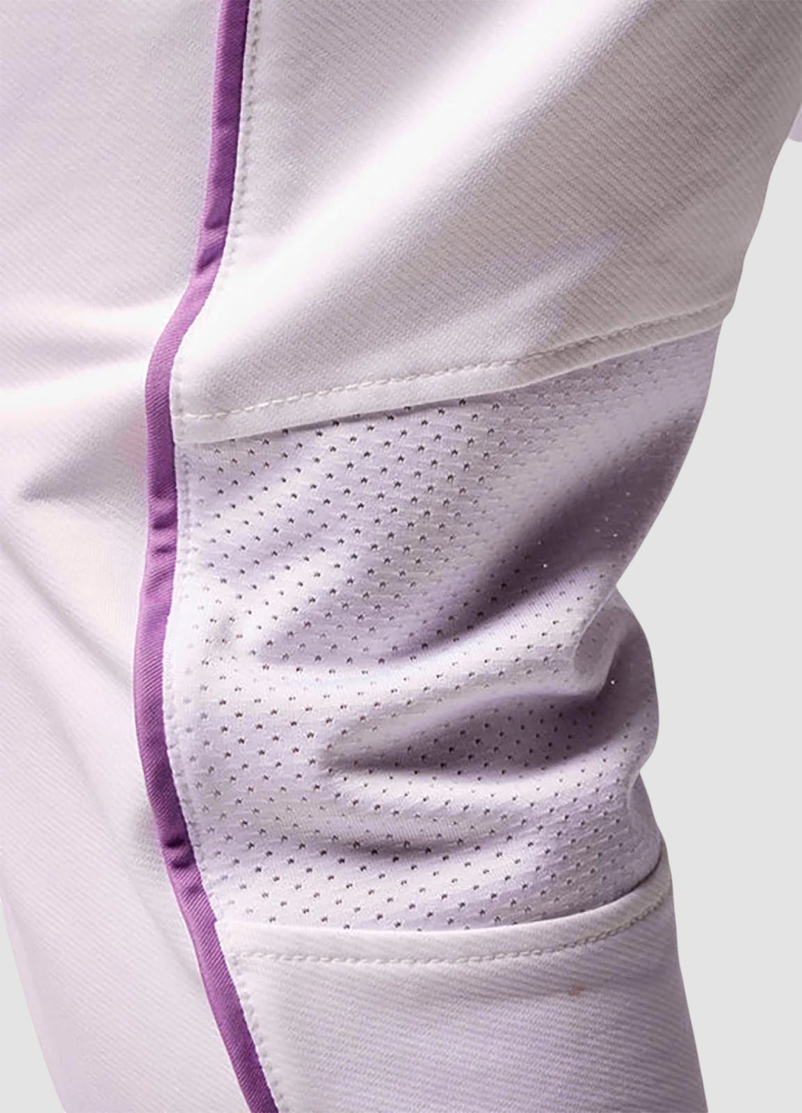 Close-up of Maiden Cricket white test match trousers featuring breathable mesh knee vents and purple piping detail.