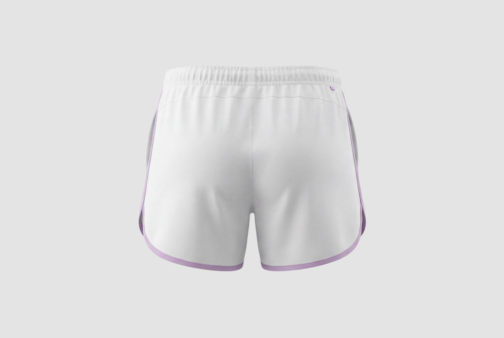 Back view of white Maiden Cricket Fine Leg Shorts for women featuring a curved hem with light purple trim.