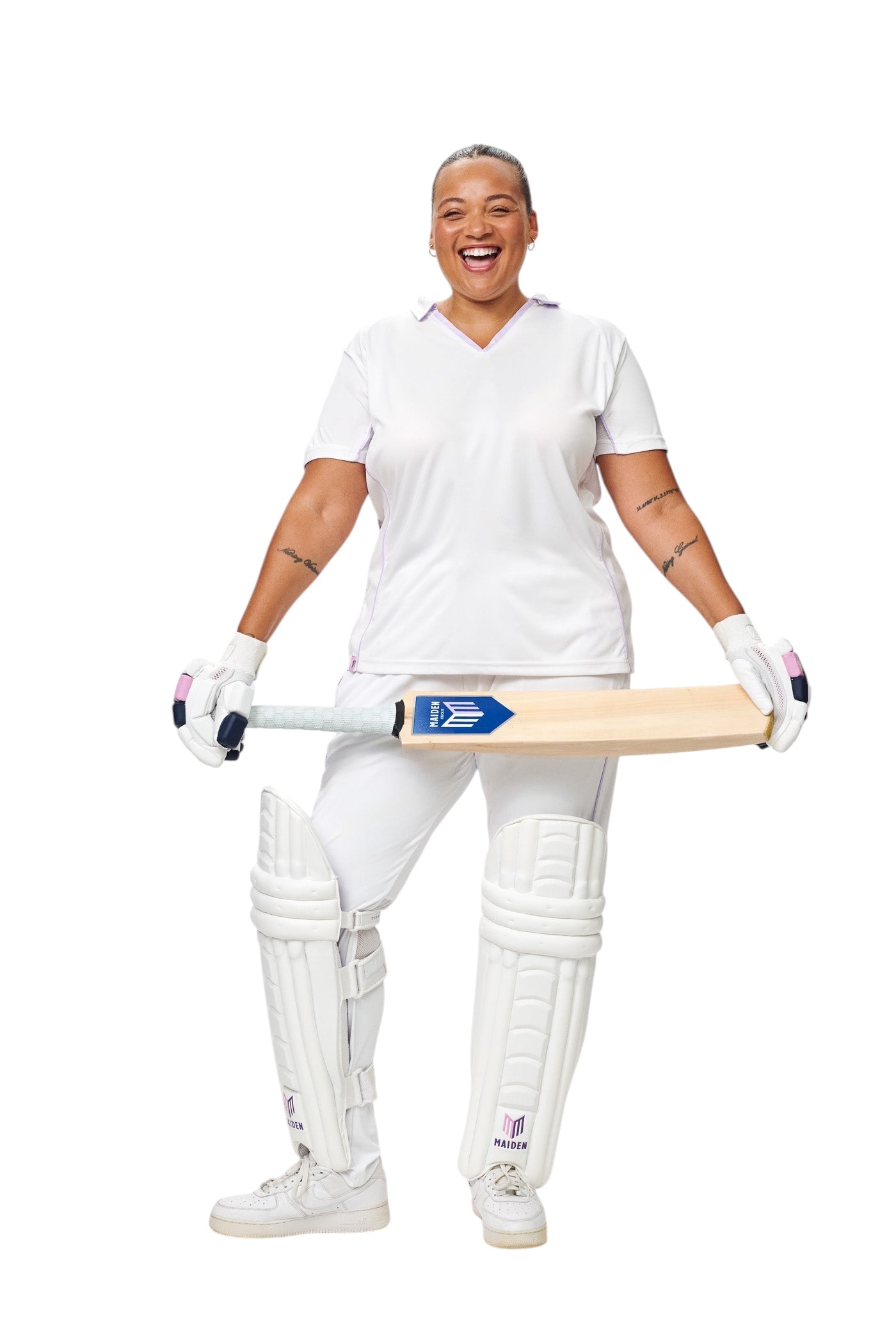 A female cricketer wearing white Maiden Cricket batting pads designed for a secure, ergonomic fit on a white background.