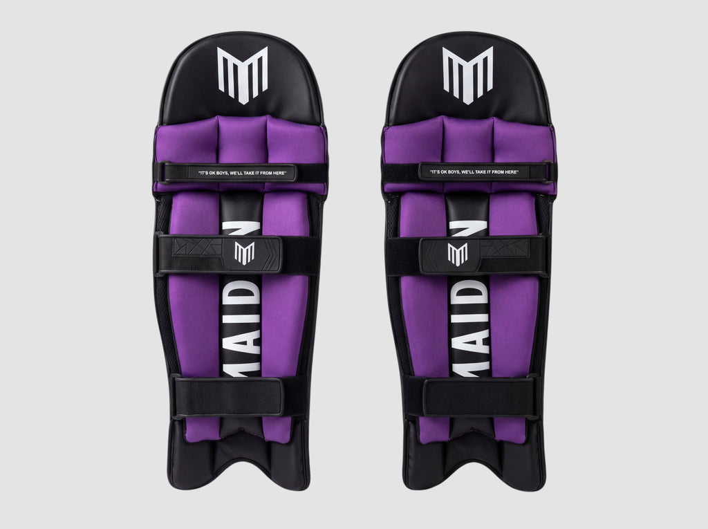 Maiden Cricket women's black and purple batting pads with ergonomic knee design and secure straps for a custom fit.
