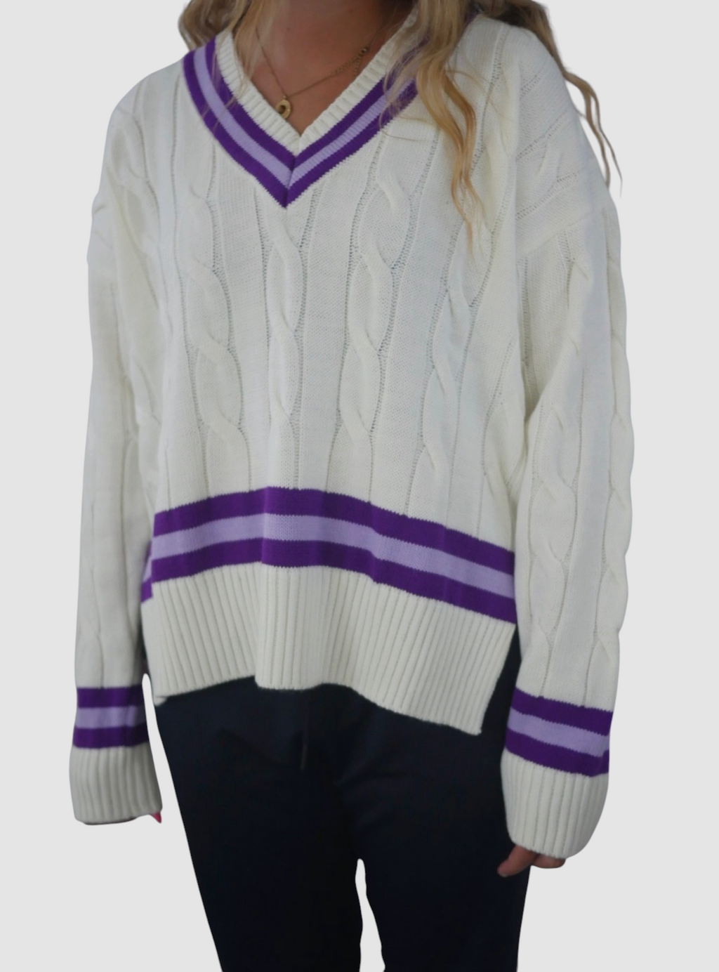 Maiden Cricket women's oversized white cable knit jumper with purple V-neck, hem and cuff detailing.