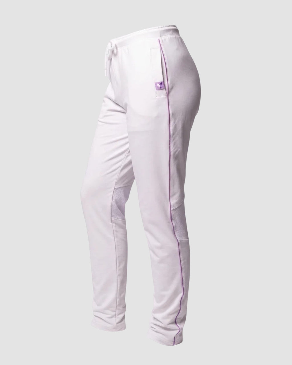 Maiden Cricket women's white cricket trousers with purple piping, mesh knee vents, and side pockets on a grey background