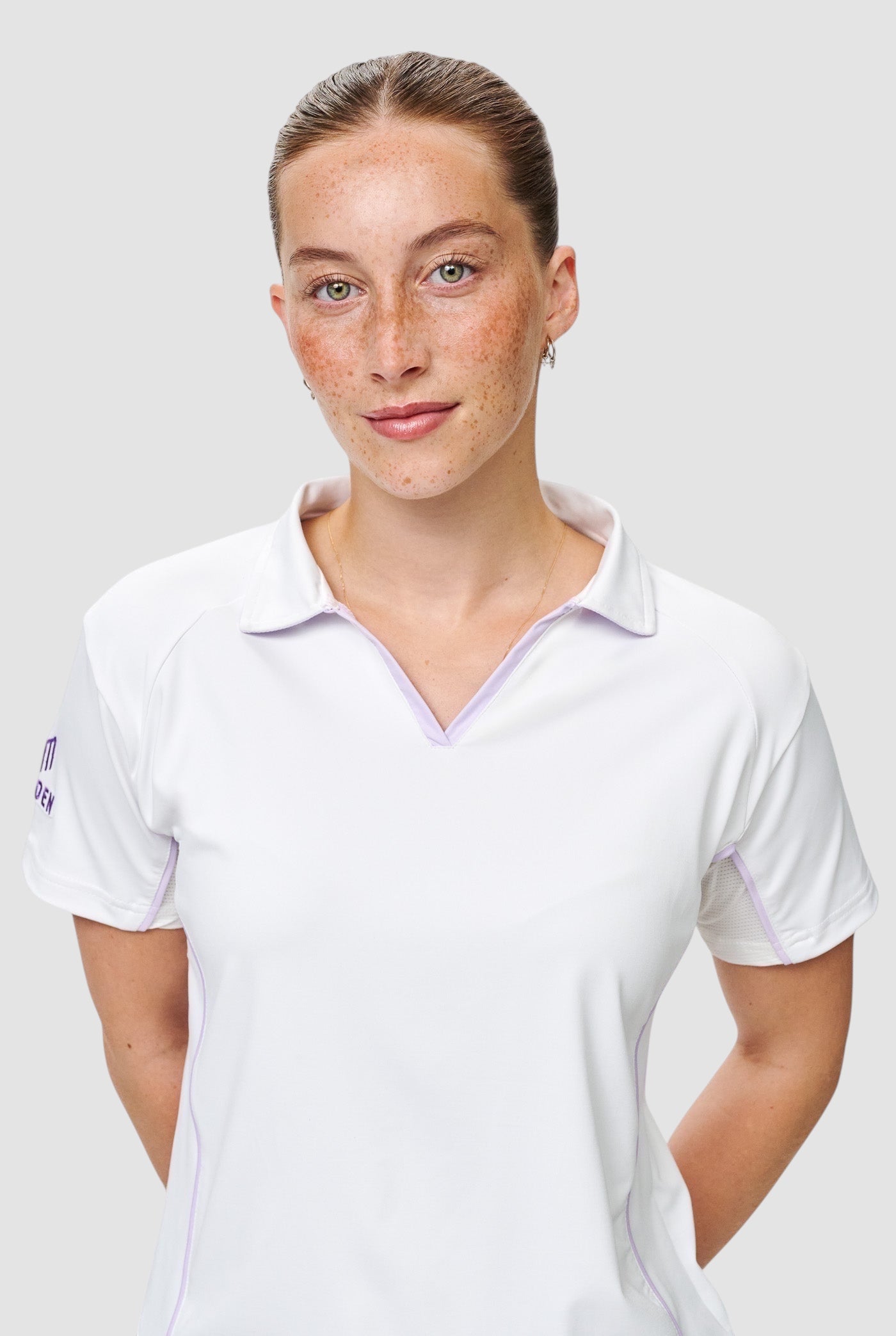 Maiden Cricket women's white V-neck performance top with mesh underarm panels for training and match days.