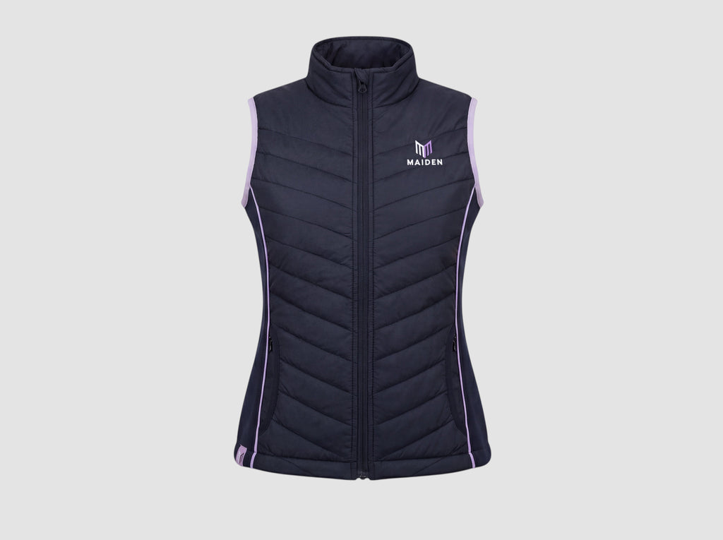 Maiden Cricket Yorker Gilet for women in navy blue with light purple trim, featuring a zip-up front and logo.