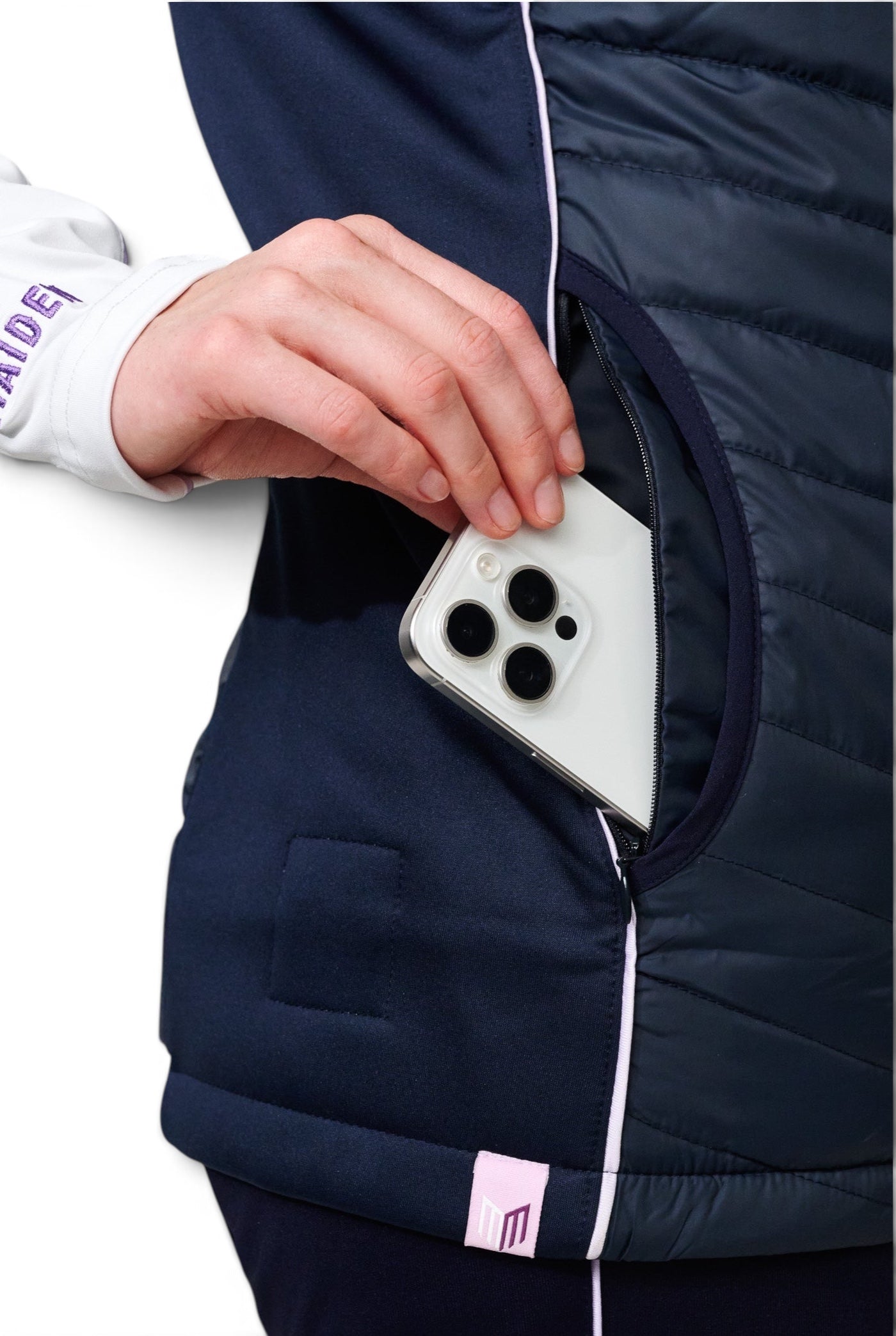 Maiden Cricket Yorker Gilet in navy with a zippered pocket holding a smartphone, showing lightweight quilted design.