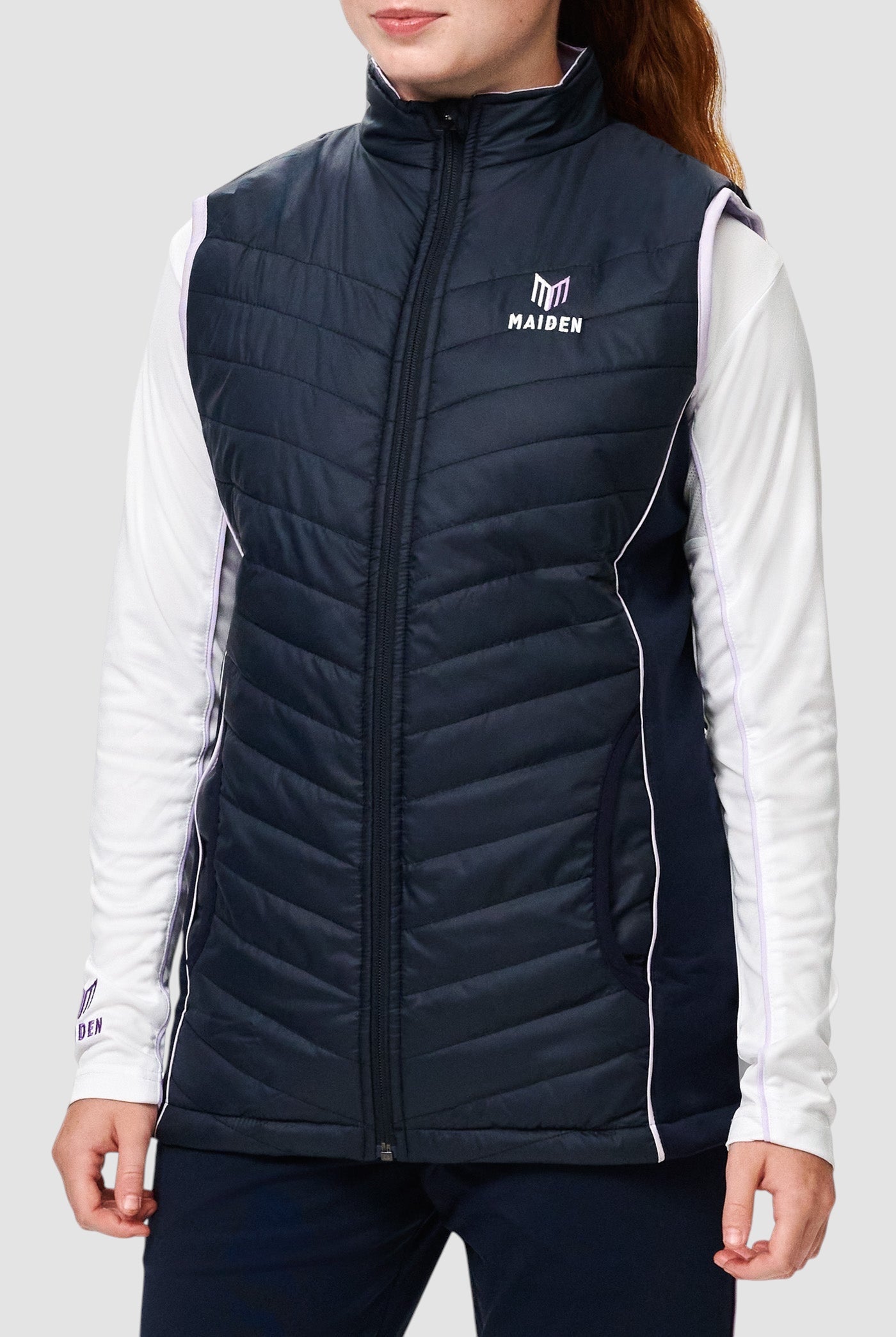 Maiden Cricket girls' navy Yorker gilet with lightweight insulation, stretch side panels, and zip-up front closure.